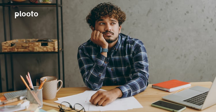 Business owner at desk with papers and laptop Business owner at desk with papers and laptop